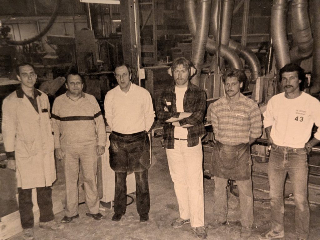 Industrial workshop team collaborating on the production floor
