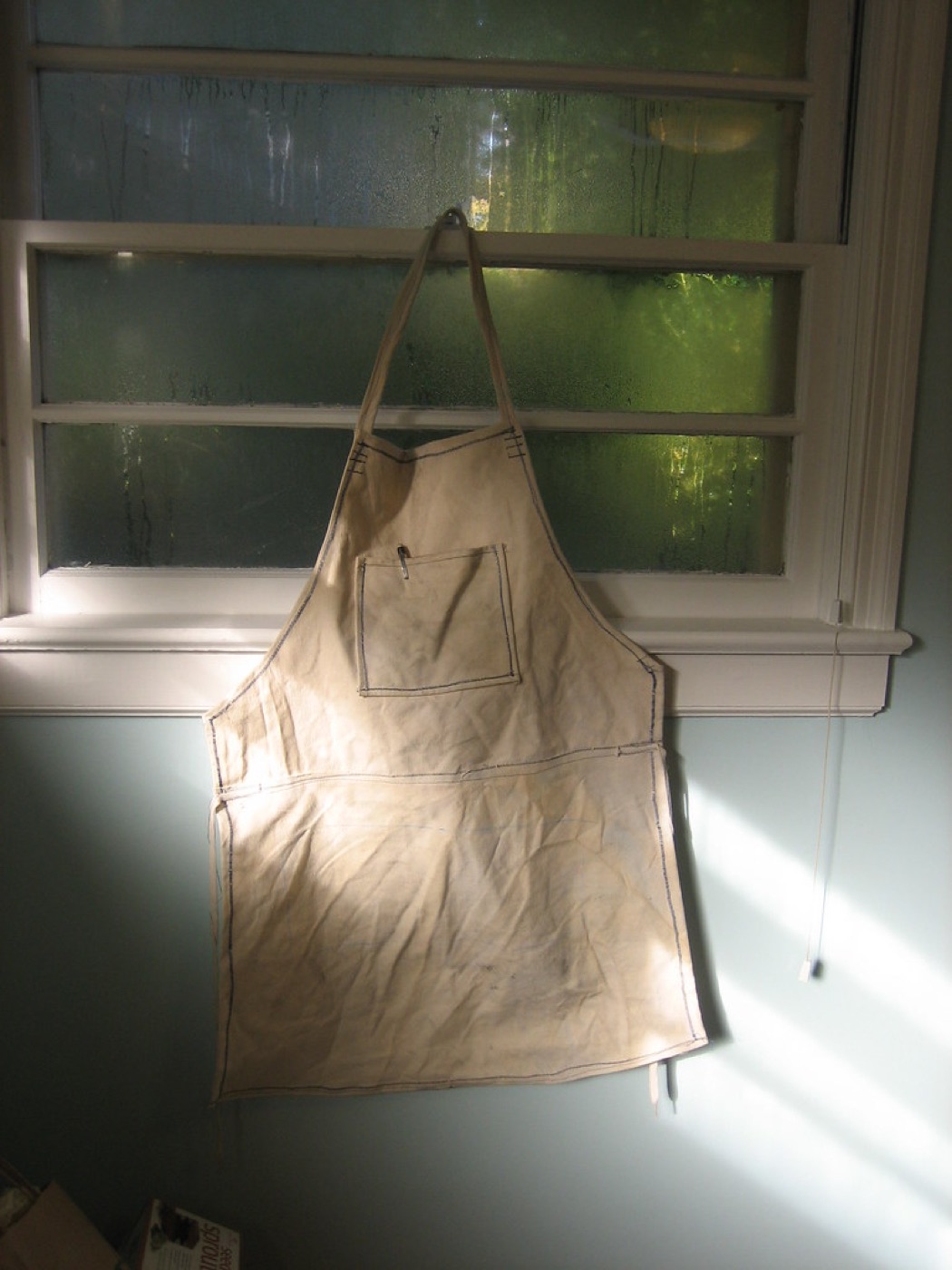 Durable canvas work apron representing workwear fabric use