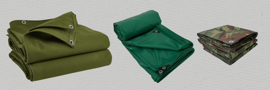 Folded green and camouflage canvas tarpaulins with eyelets