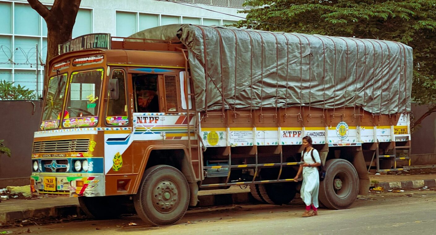 Indian goods truck with its load covered by a canvas tarpaulin