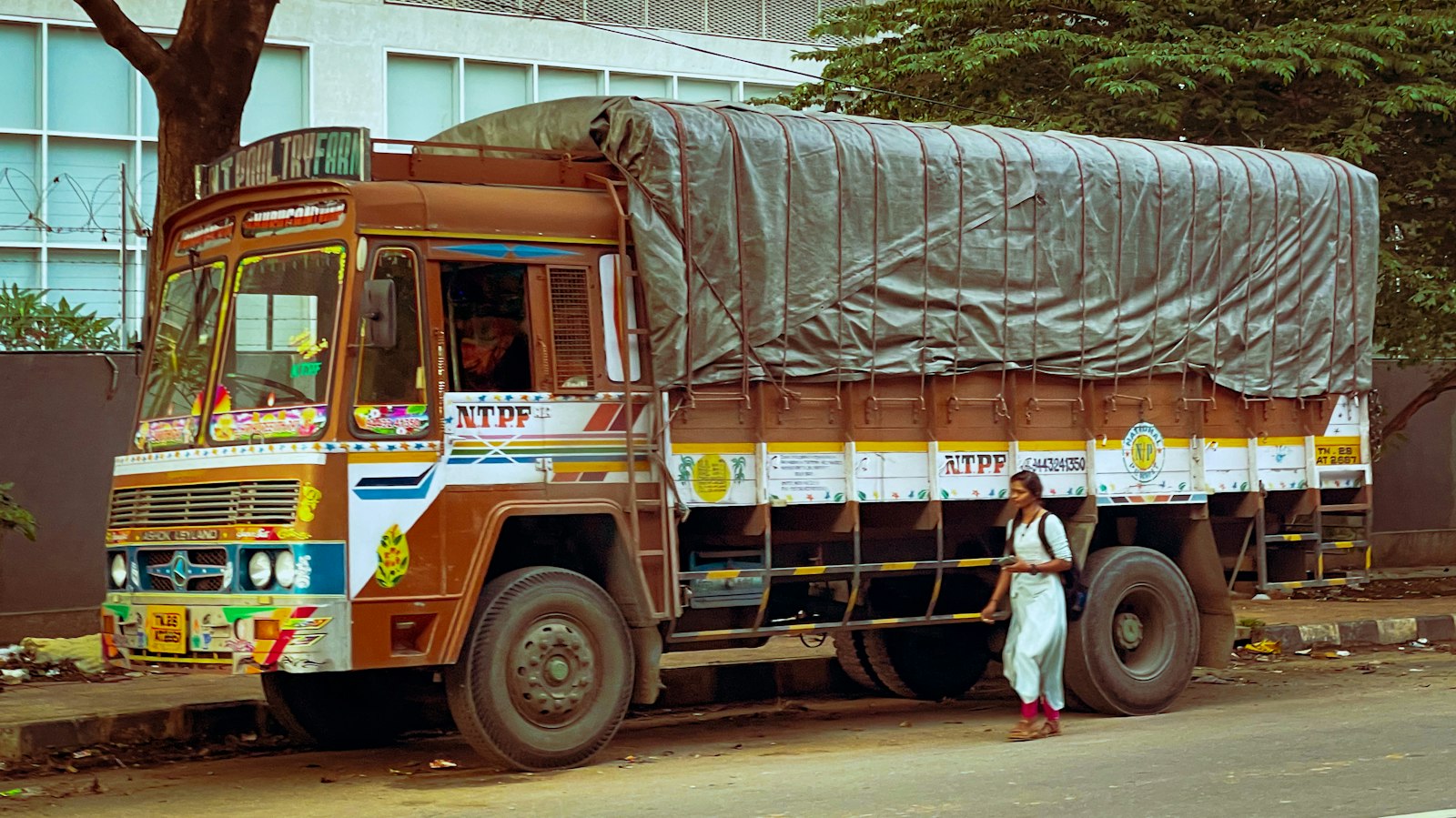 Indian goods truck with its load covered by a canvas tarpaulin