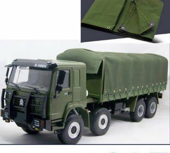 Olive green canvas tarpaulin used as a truck cover, with eyelet edge detail