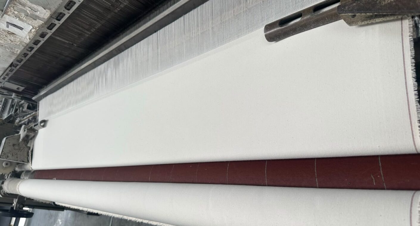 Cotton canvas fabric being woven on a loom at the A K Industrial Fabrics mill in Kanpur