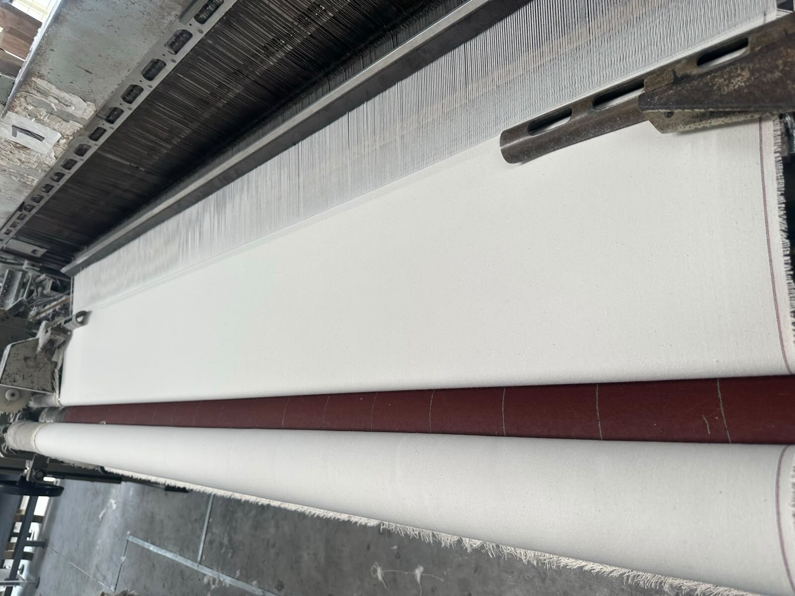 Cotton canvas fabric being woven on a loom at the A K Industrial Fabrics mill in Kanpur